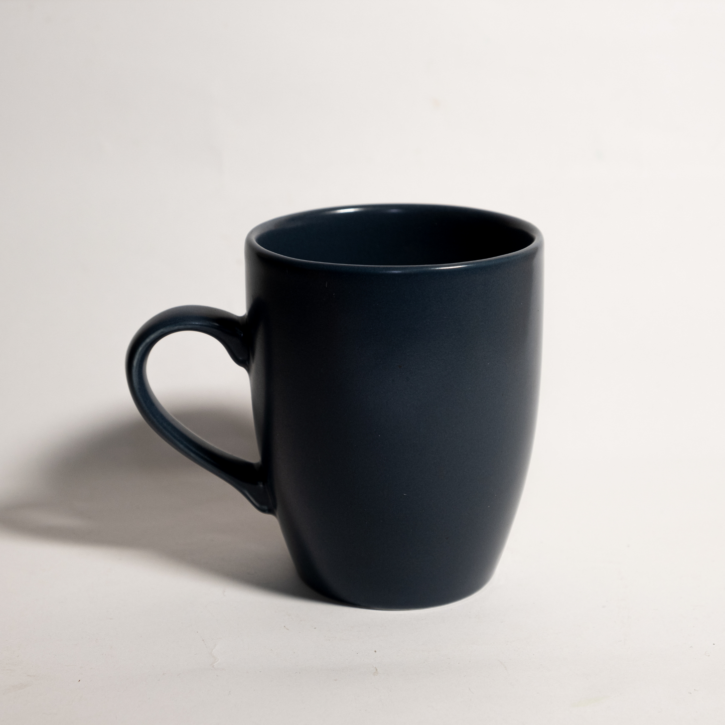 Handmade ceramic coffee mug in blue. The mug is made of high-quality ceramic and is dishwasher and microwave safe. It is the perfect gift for any coffee lover.